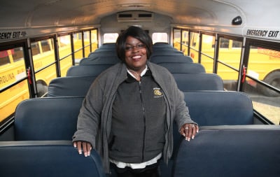 Robin Small, a bus driver for Chapel Hill-Carrboro City Schools stands in one of three buses that have stop arm cameras. (Photo Credit: UNC's School of Journalism and Mass Communication)