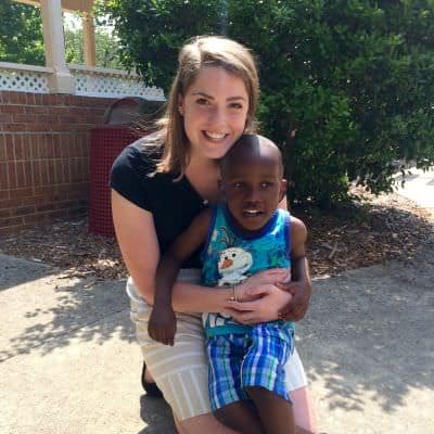 Maggie Pearce with Edmund, a Pre-K student, at the Tammy Lynn Center playground.