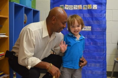 Teacher assistant Ron Smith with a Pearsontown student (Photo Credit/Alex Granados)