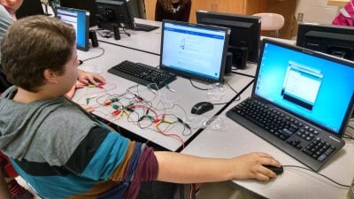 Student testing wiring and code for a wearable tech device (Photo courtesy: Erik Schettig)