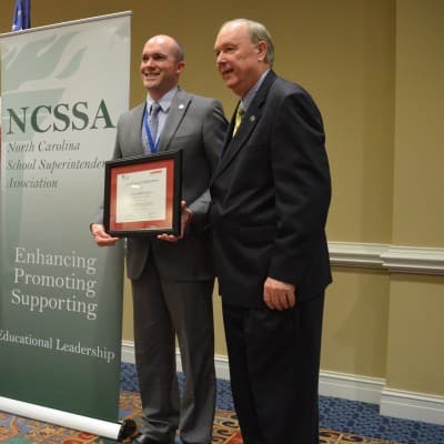 From left, Watauga County Superintendent Scott Elliot and Jack Hoke during the graduation portion of The Next Generation Superintendent Development Program (Photo Credit/Alex Granados)