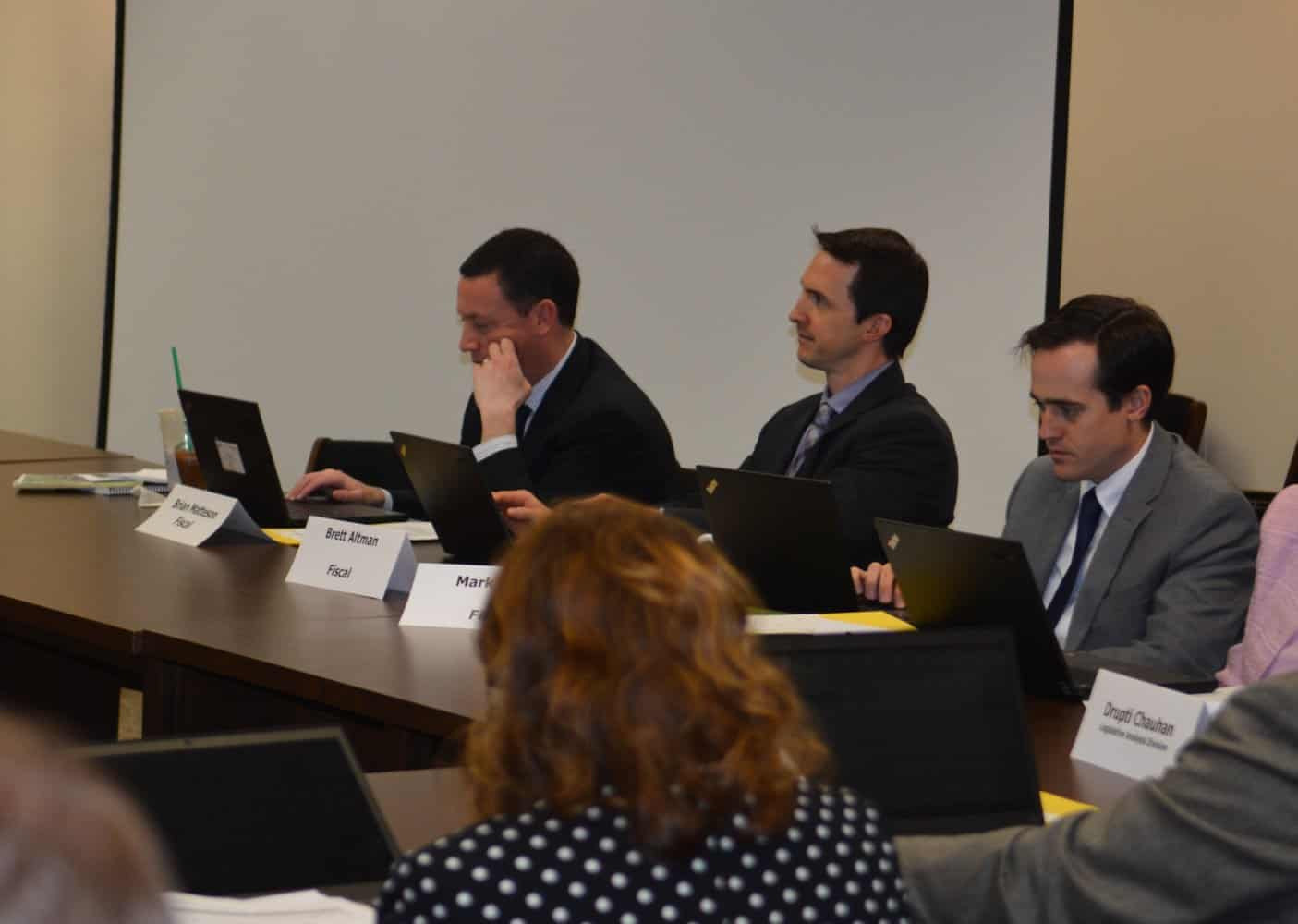 Fiscal analyst Brian Matteson is on the left.