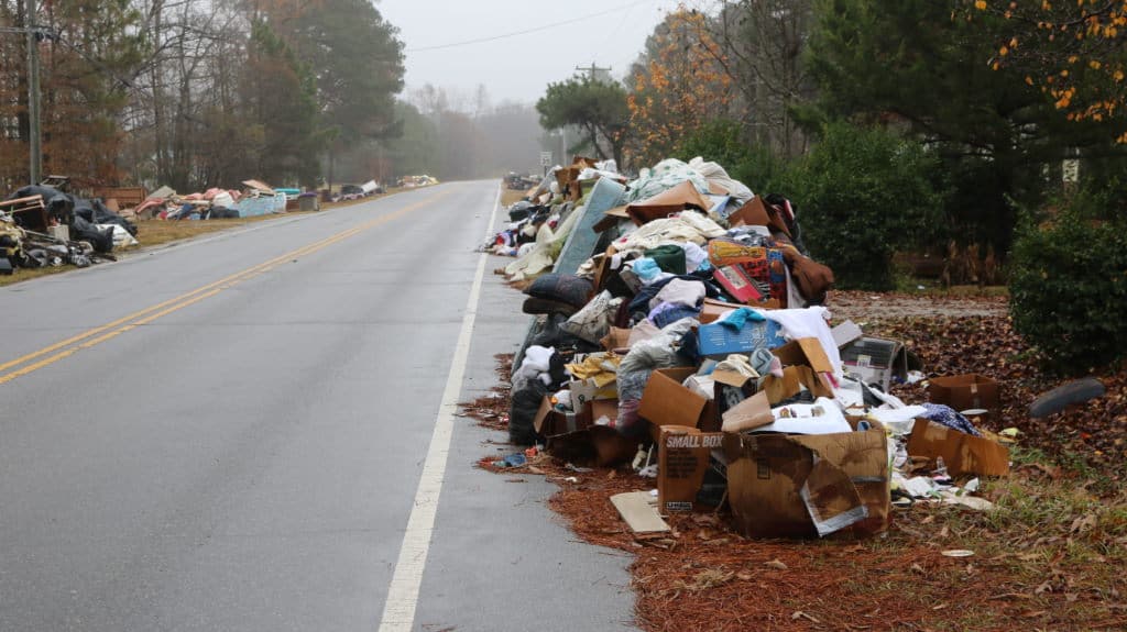 Residents' ruined belongings from Hurricane Matthew flooding line a street in Princeville. (Photo Credit: Liz Bell/EducationNC)