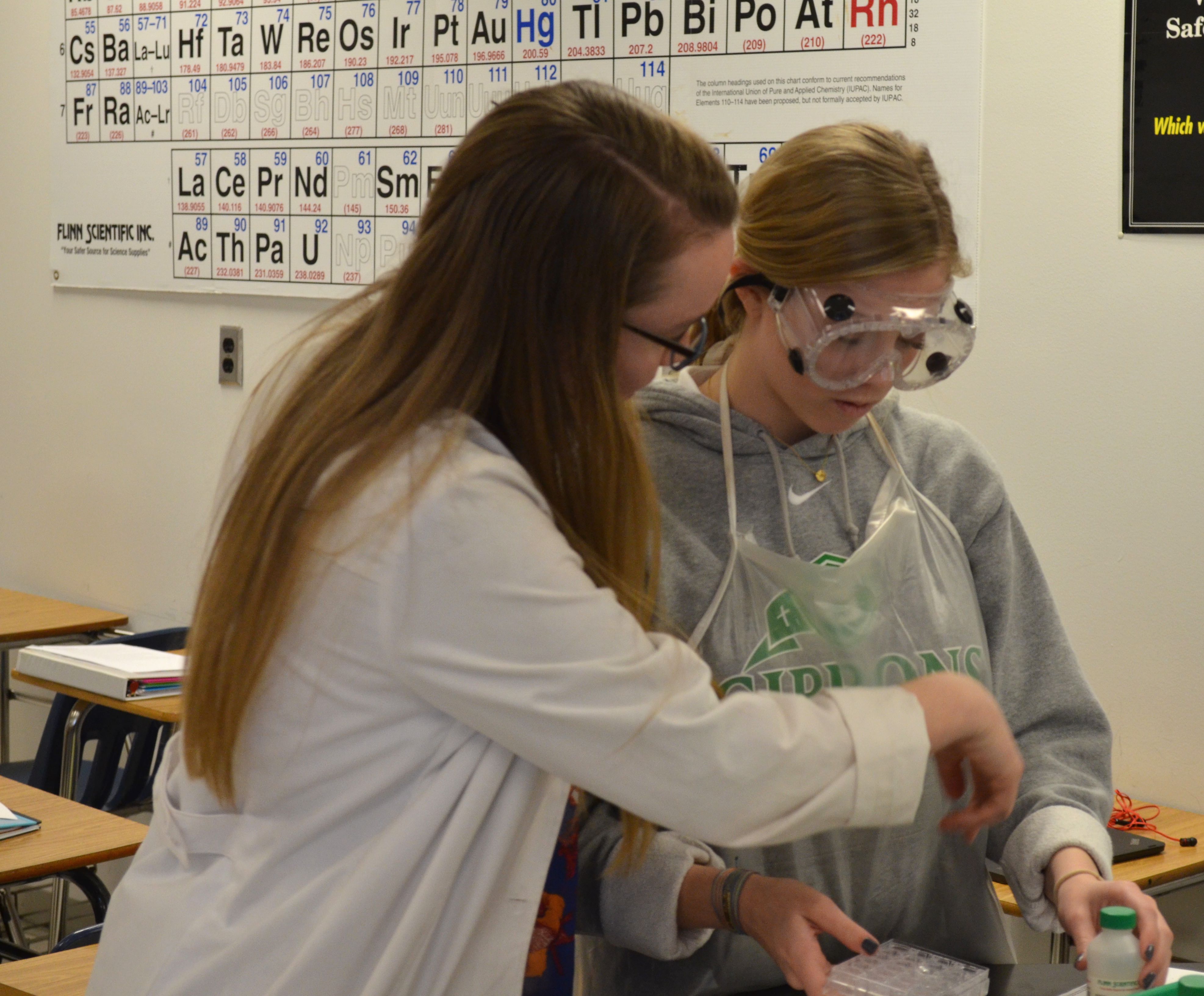 Katie Quigley, left, helping one of her students (Photo Credit: Alex Granados/EducationNC)