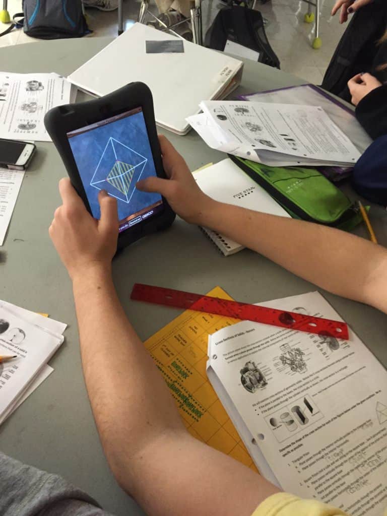 Students in Mr. Ferguson's Honors Math 2 class at Leesville Road High School in Raleigh explore geometric cross-sections using an iPad app. 