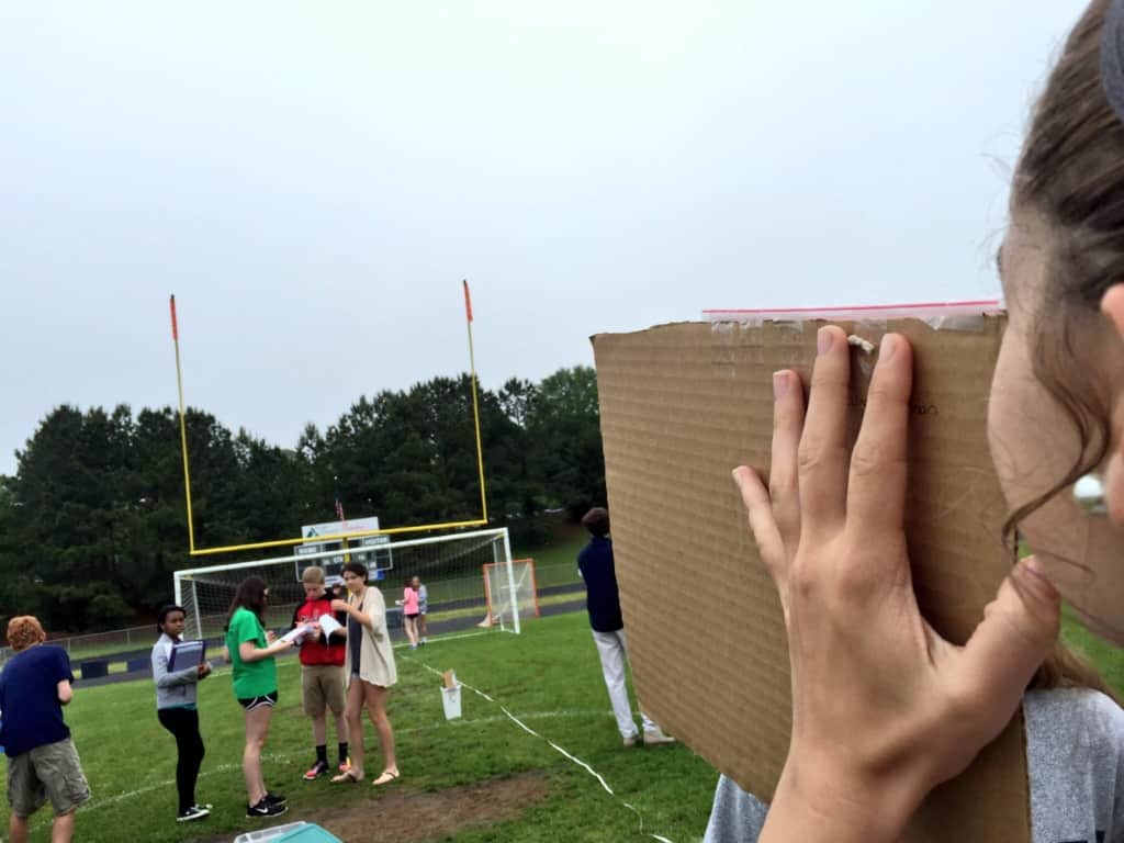 Students in Mr. Ferguson's Honors Math 2 class utilize trigonometric ratios to measure field goal posts using student-made hypsometers. 