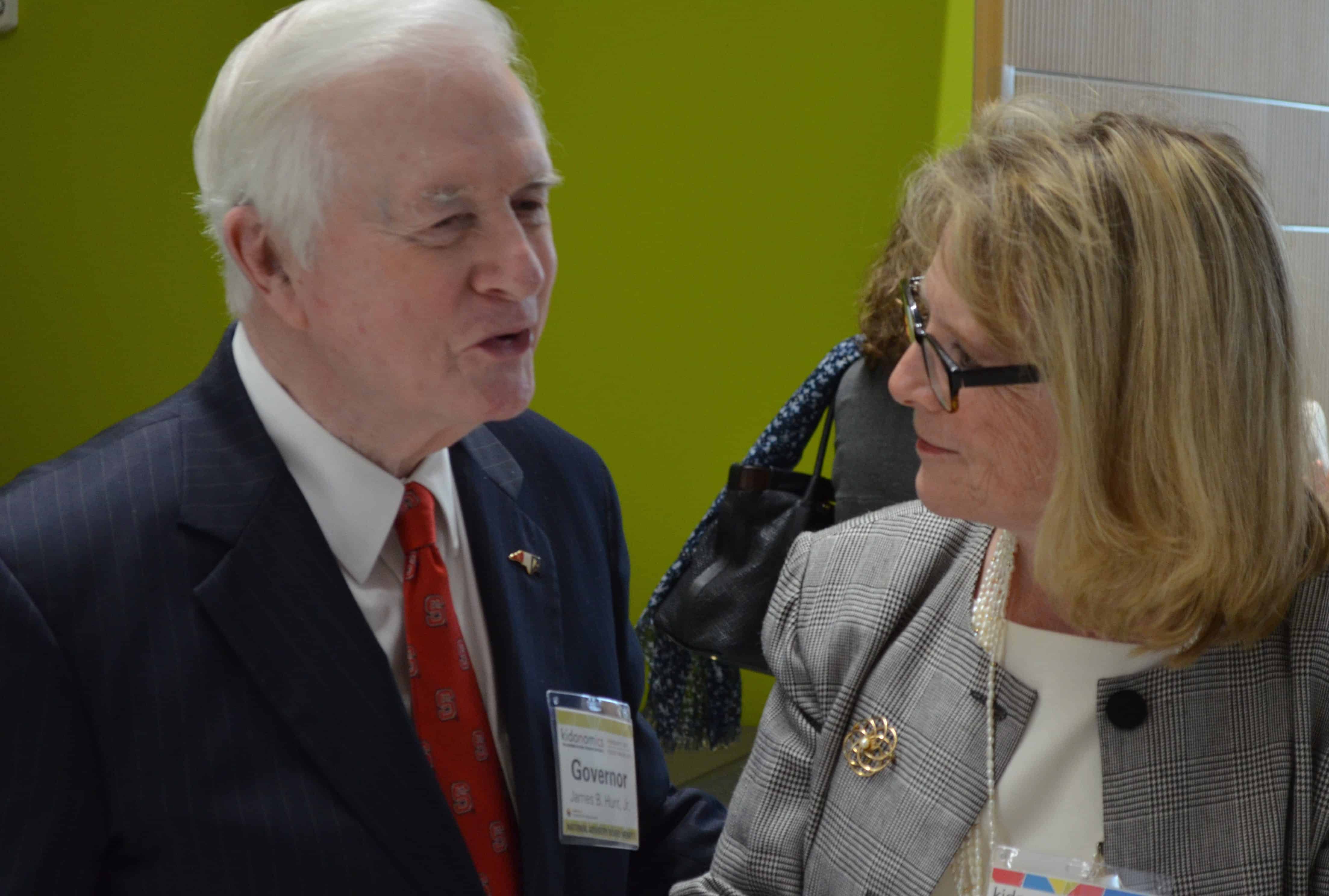 Former NC Governor Jim Hunt, left, chats during kidoNomiCs event. 