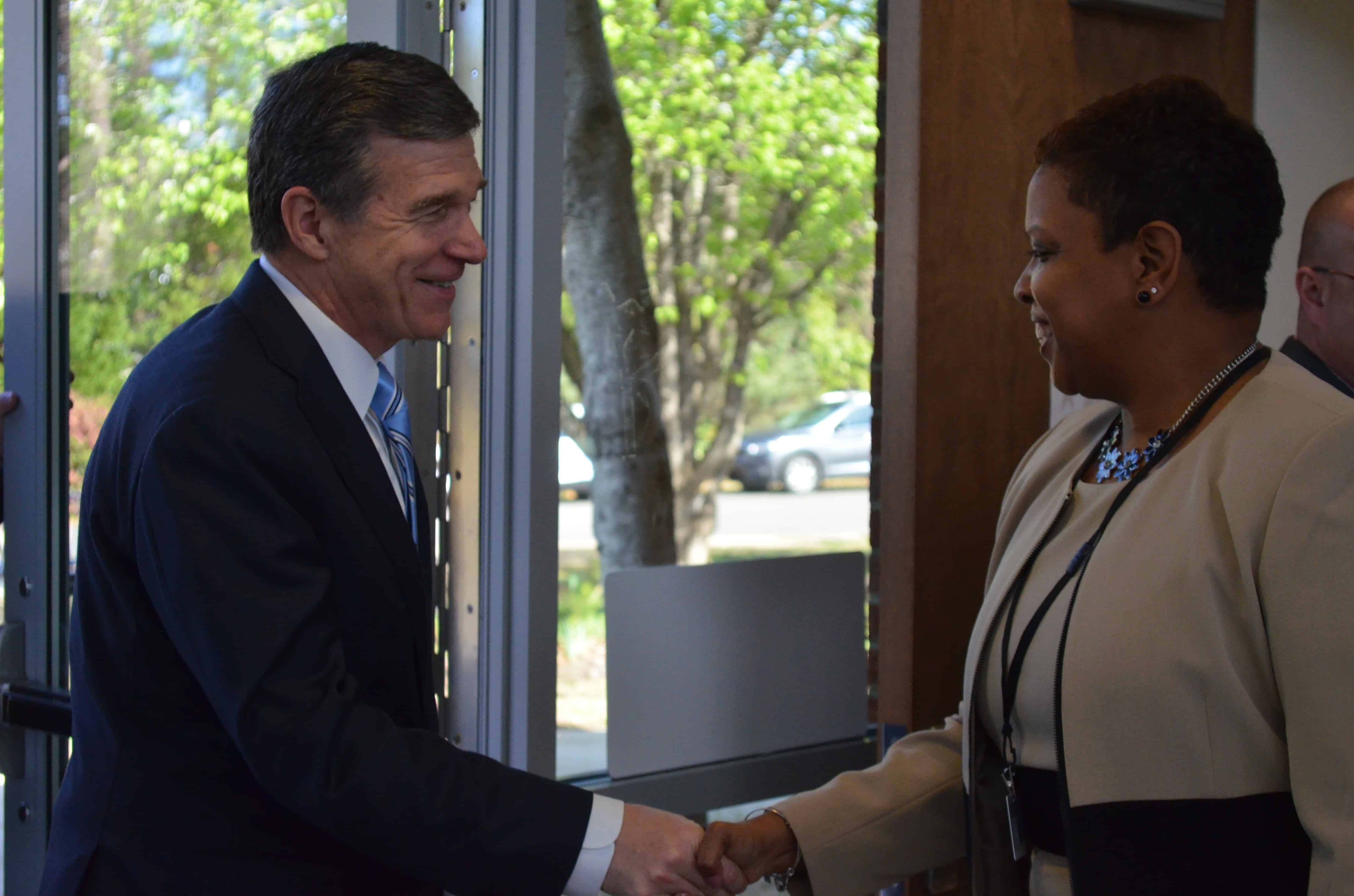 Governor Roy Cooper greets Parkwood Elementary Principal Michelle Bell