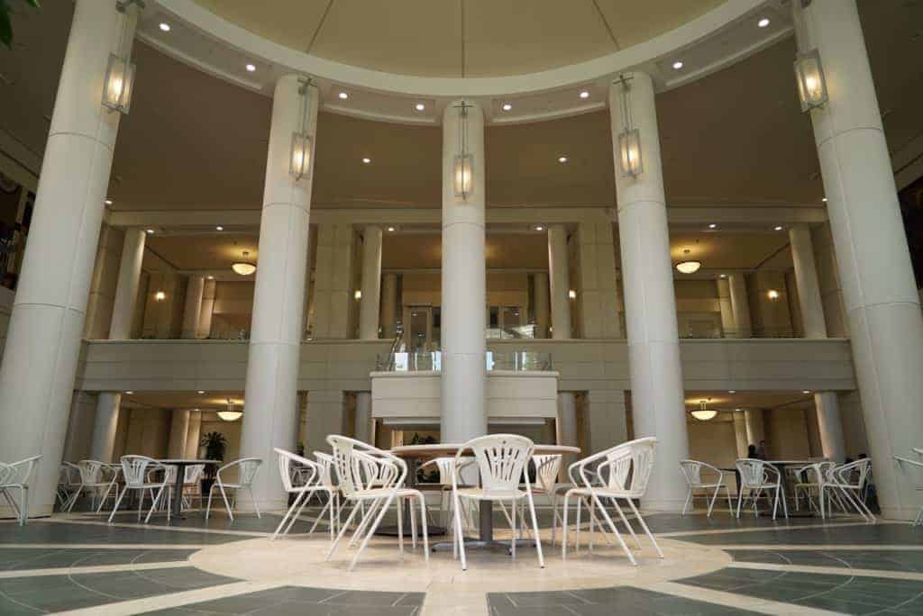 A large open room with tables, chairs, and a high ceiling