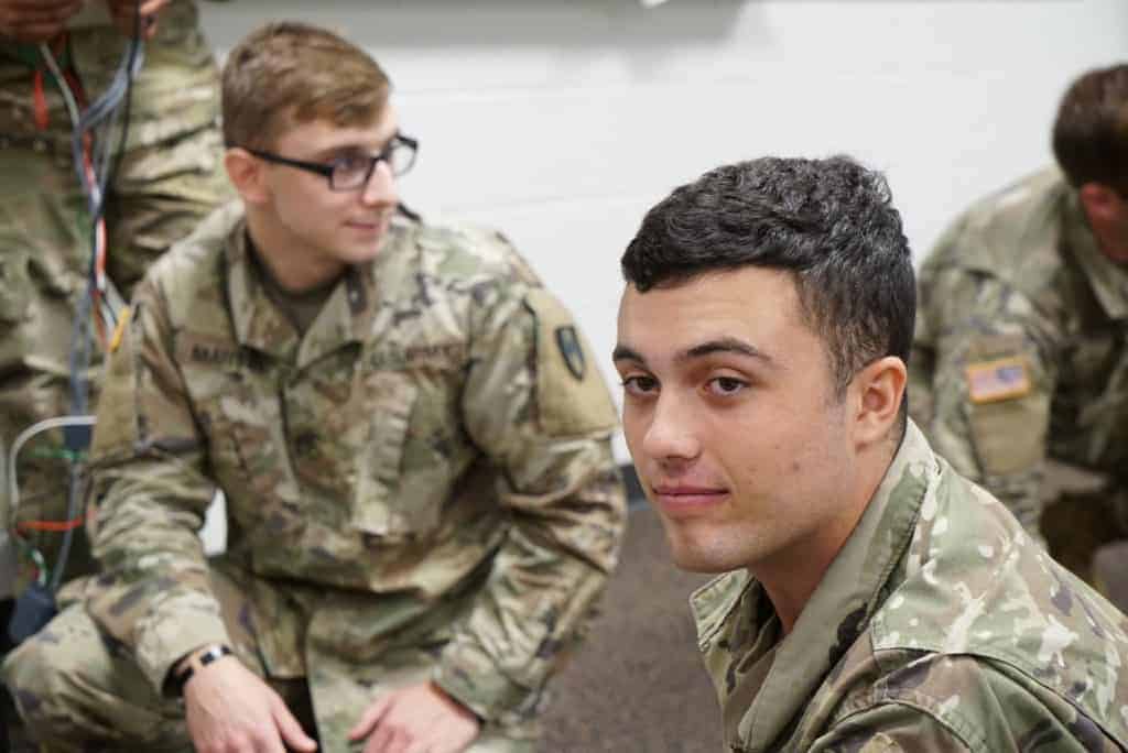 Students in army uniforms in a classroom