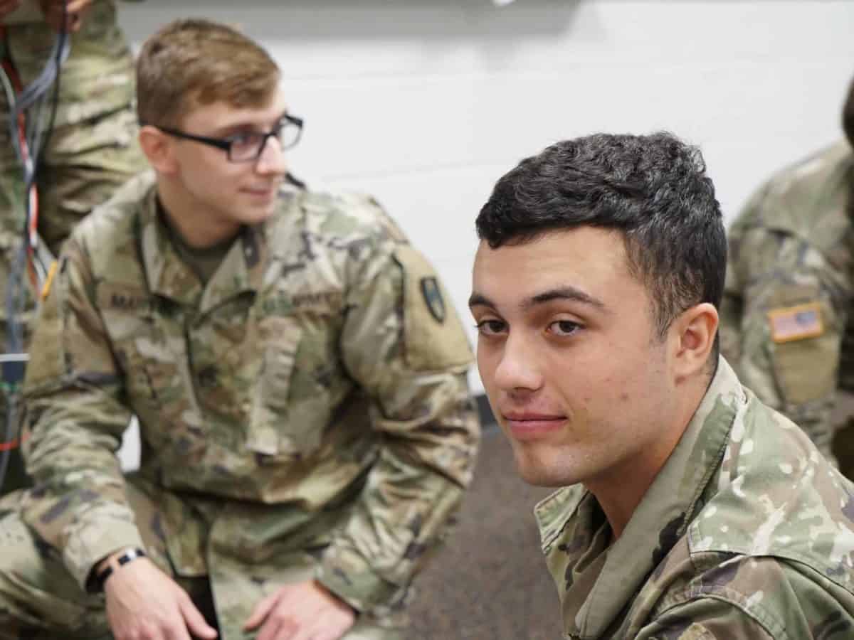 Students in army uniforms in a classroom