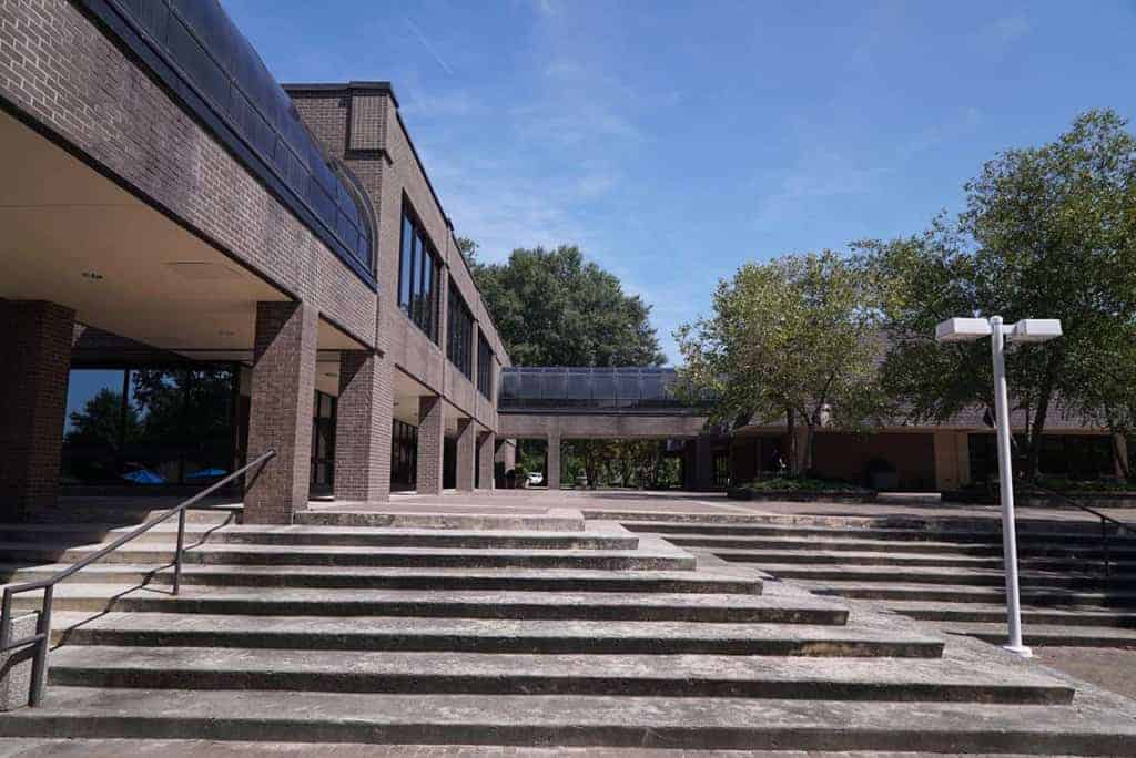 A brick staircase leads to two-story campus buildings.