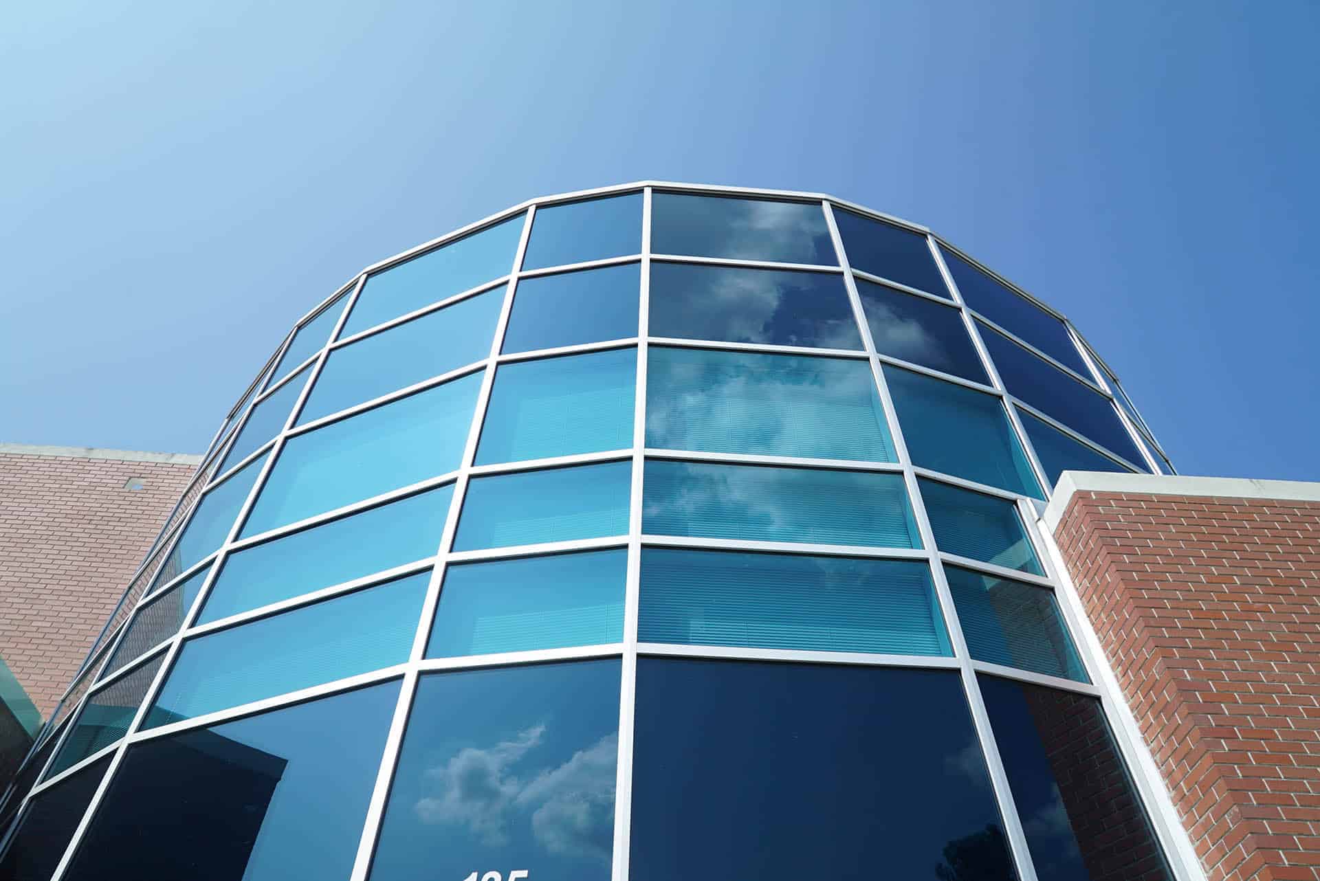 Up close on building, round pane of windows and brick