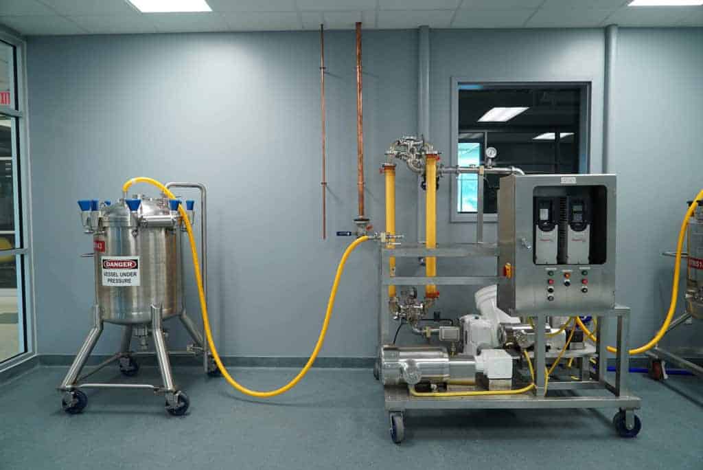 Metal machinery connected with yellow tubing