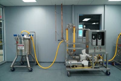 Metal machinery connected with yellow tubing