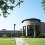 a round building with glass and brick