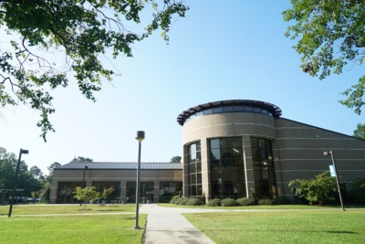 a round building with glass and brick