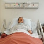 a mannequin laying in hospital bed
