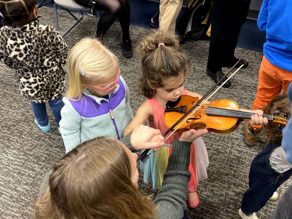 Girl playing the violin with the NC Symphony. Caroline Parker/EducationNC