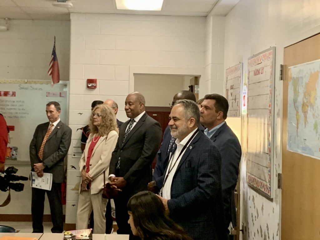 people standing by classroom door