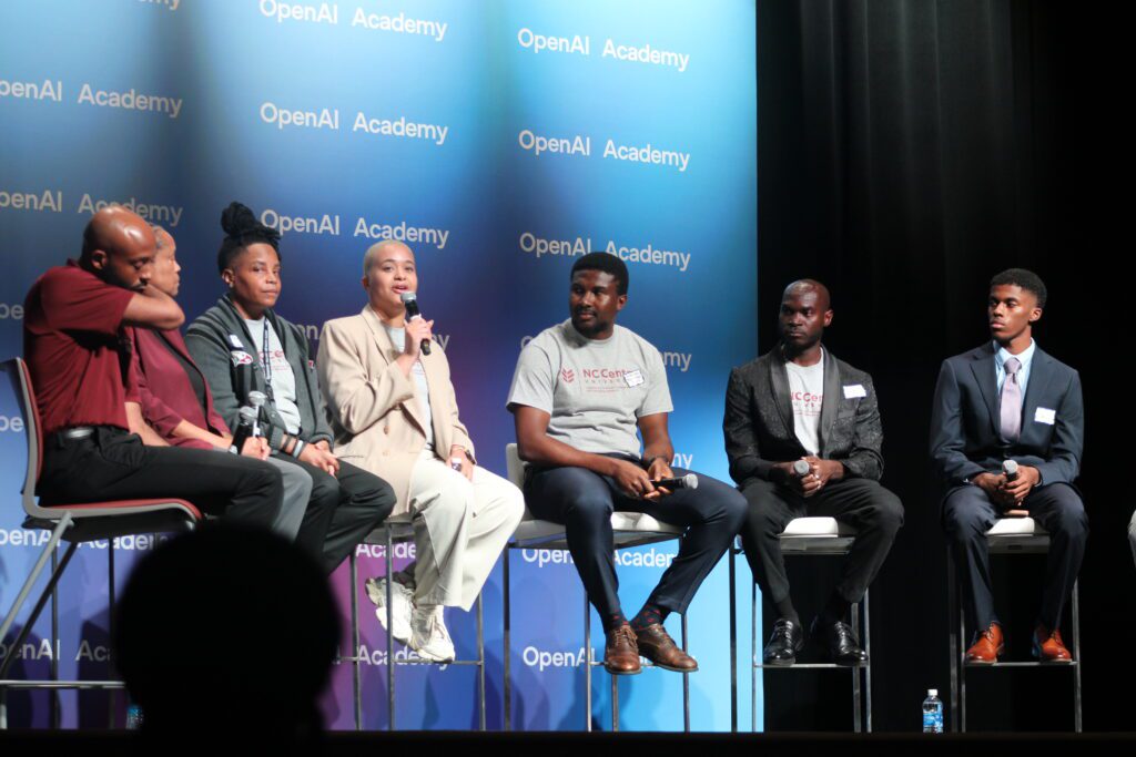 students sitting on a stage