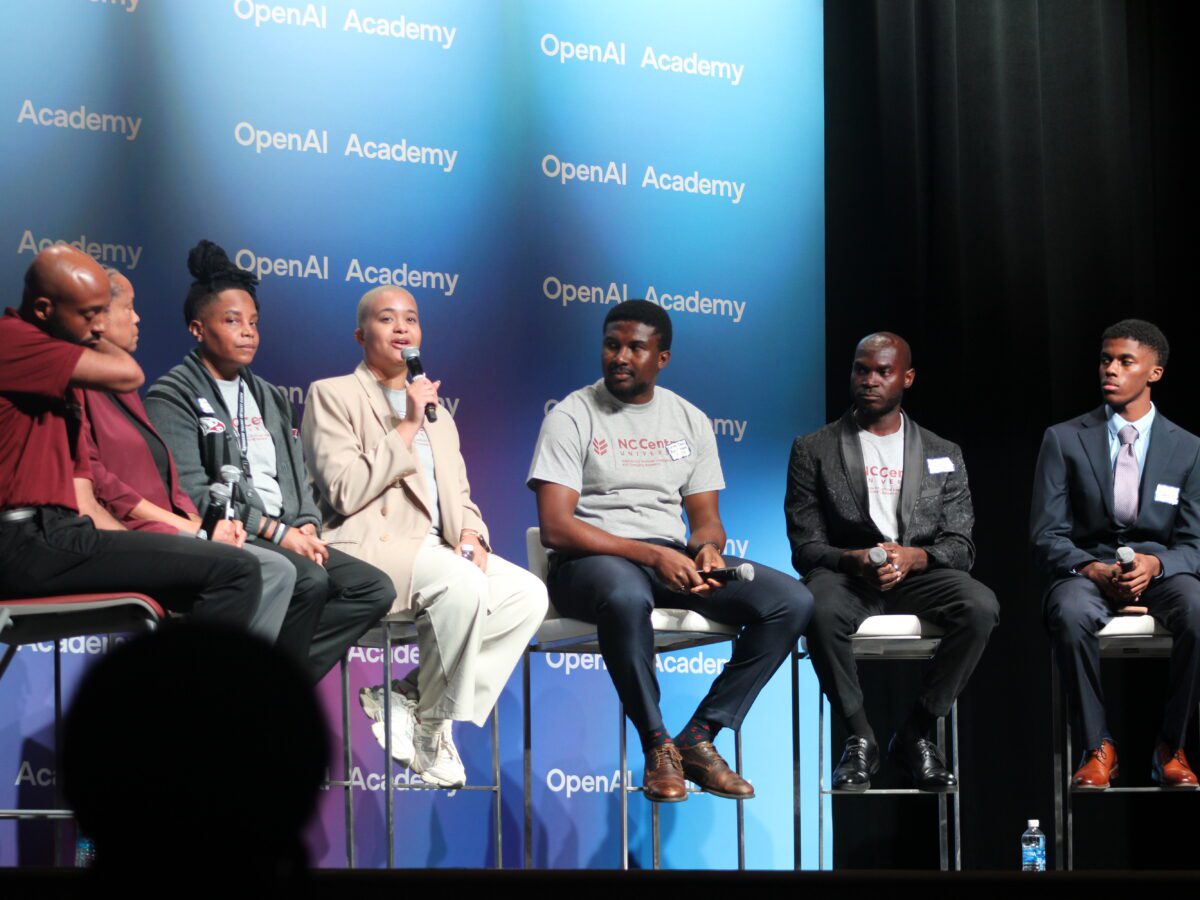 students sitting on a stage