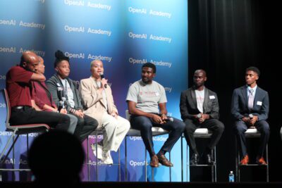 students sitting on a stage