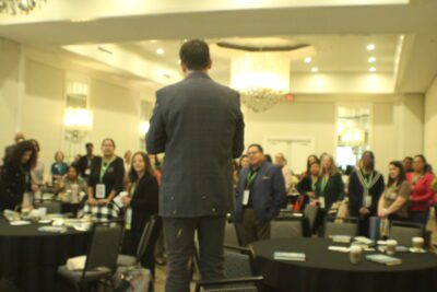 back of man's head in front of crowd