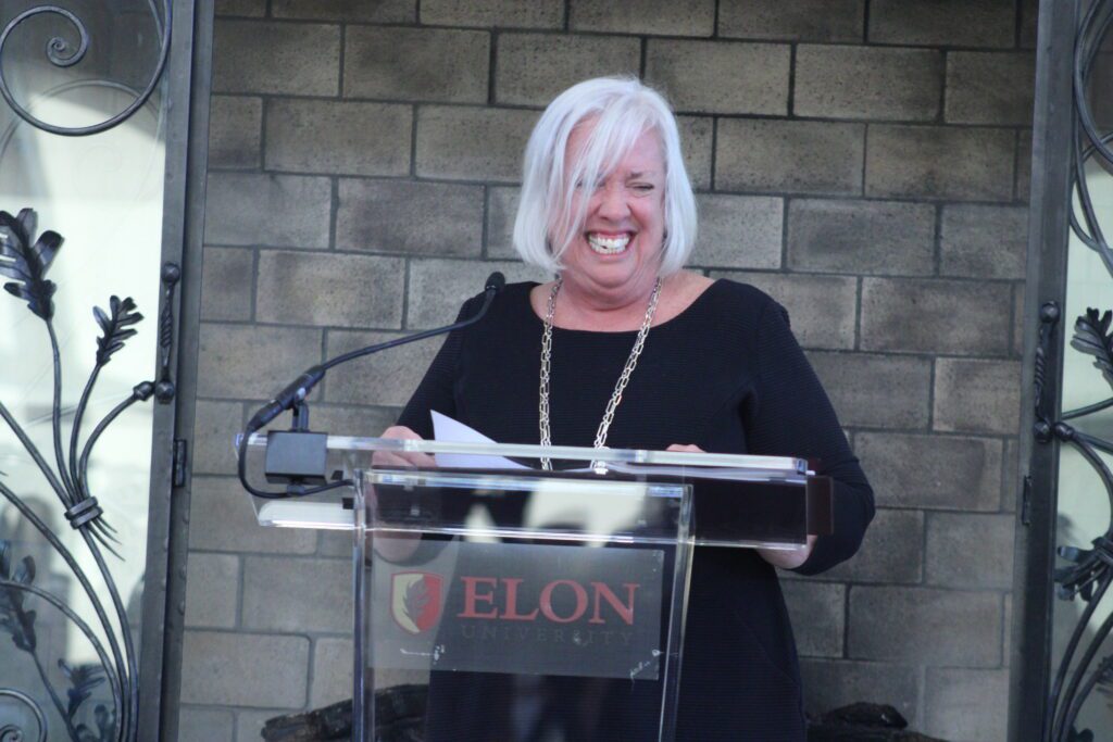 woman grinning at podium