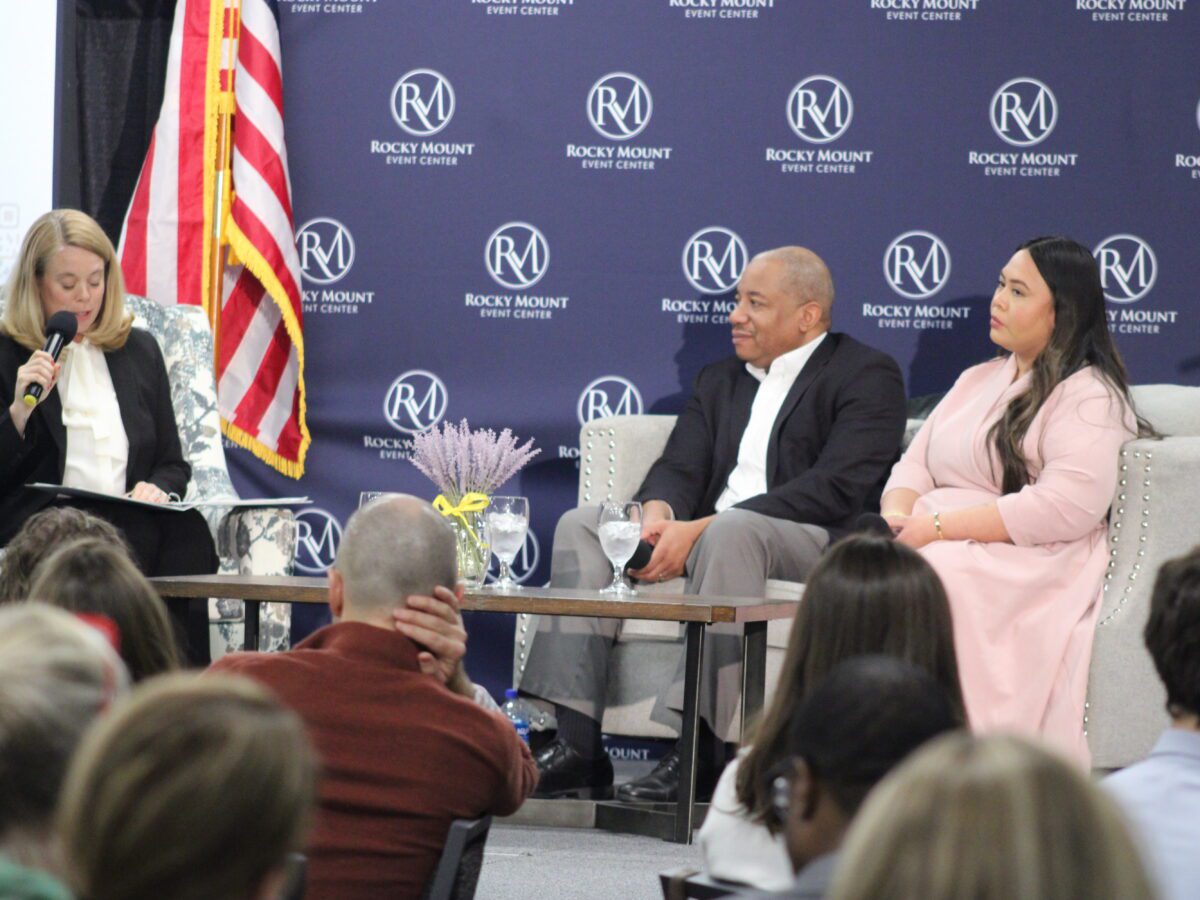 people seated n couches with microphones