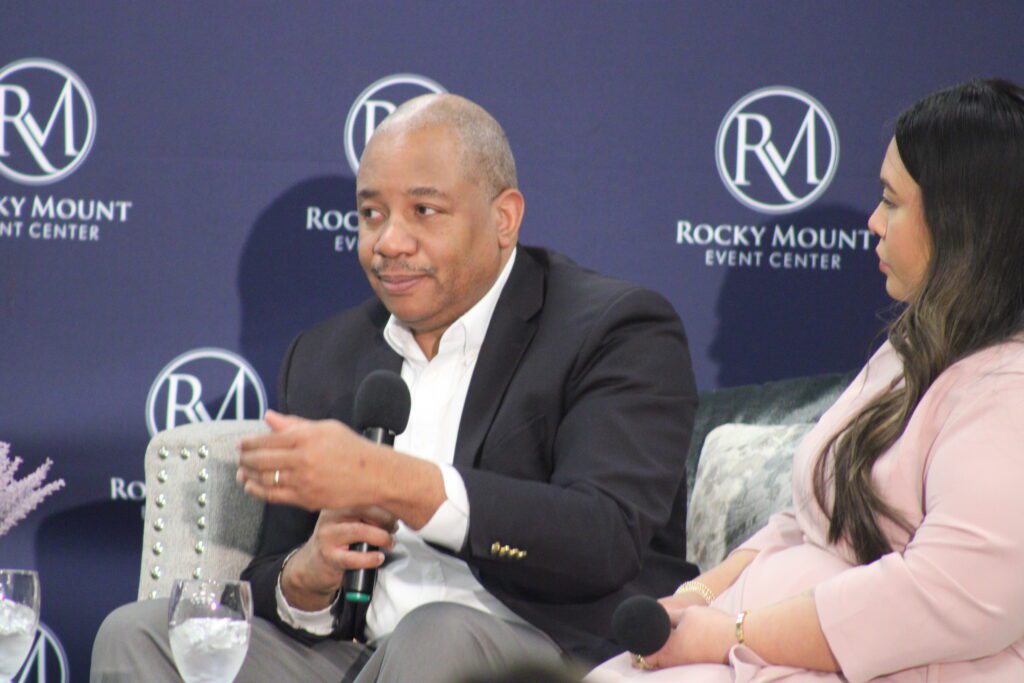 mo green seated with mic in hand