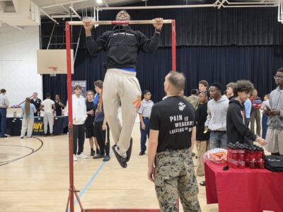 people doing pull ups in a high school gym