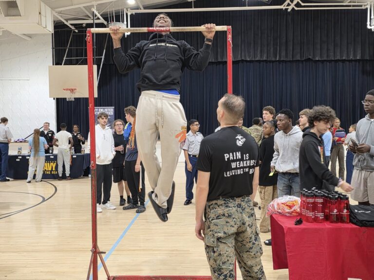 people doing pull ups in a high school gym