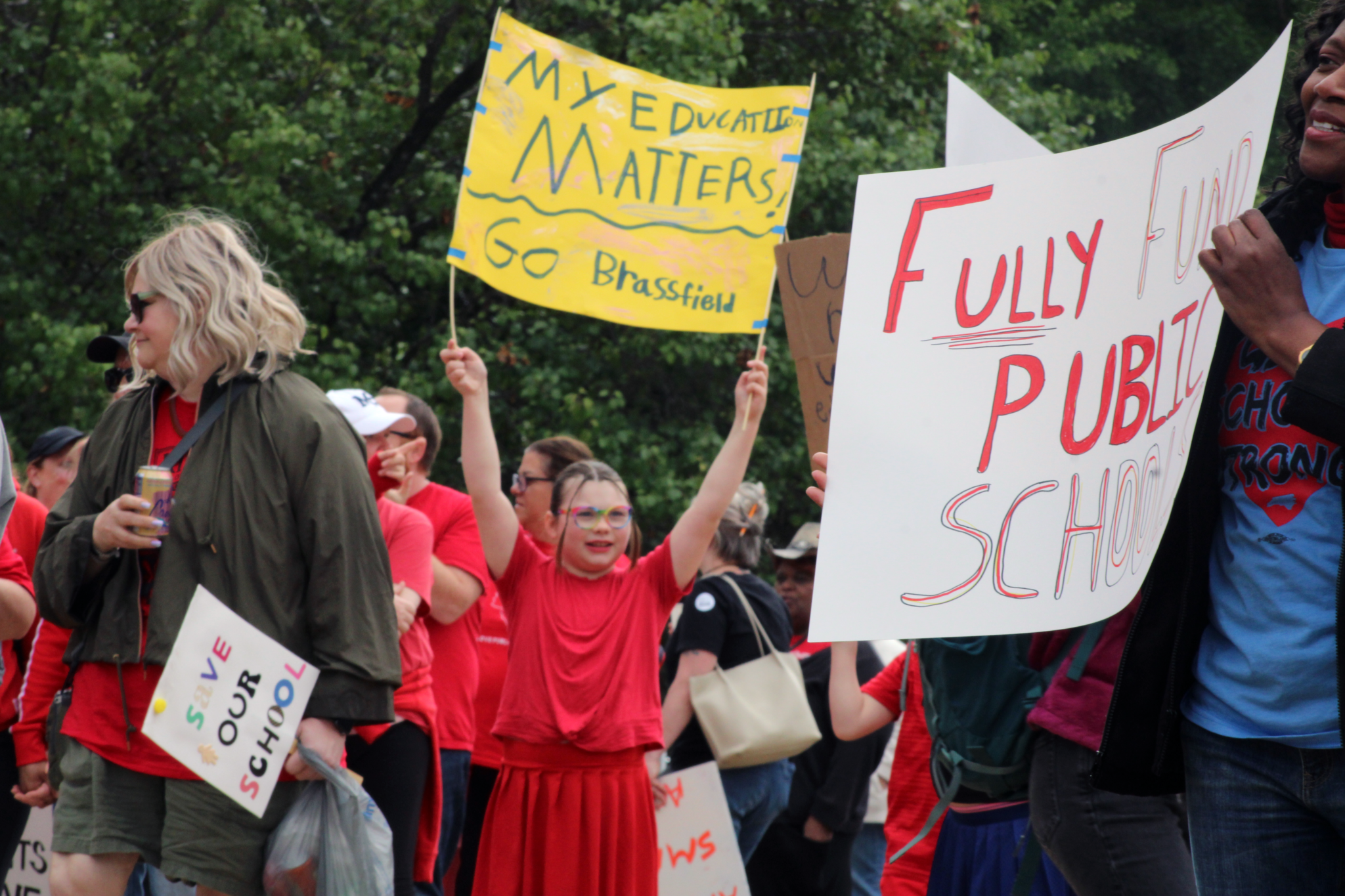 people with sign saying my education matters go brassfield