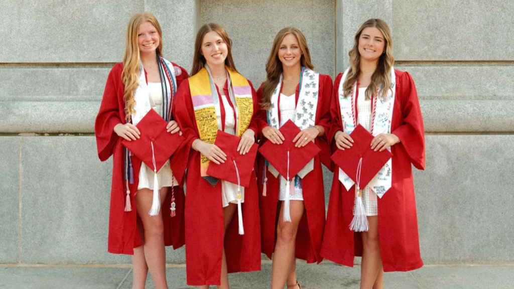 four women with graduation gear