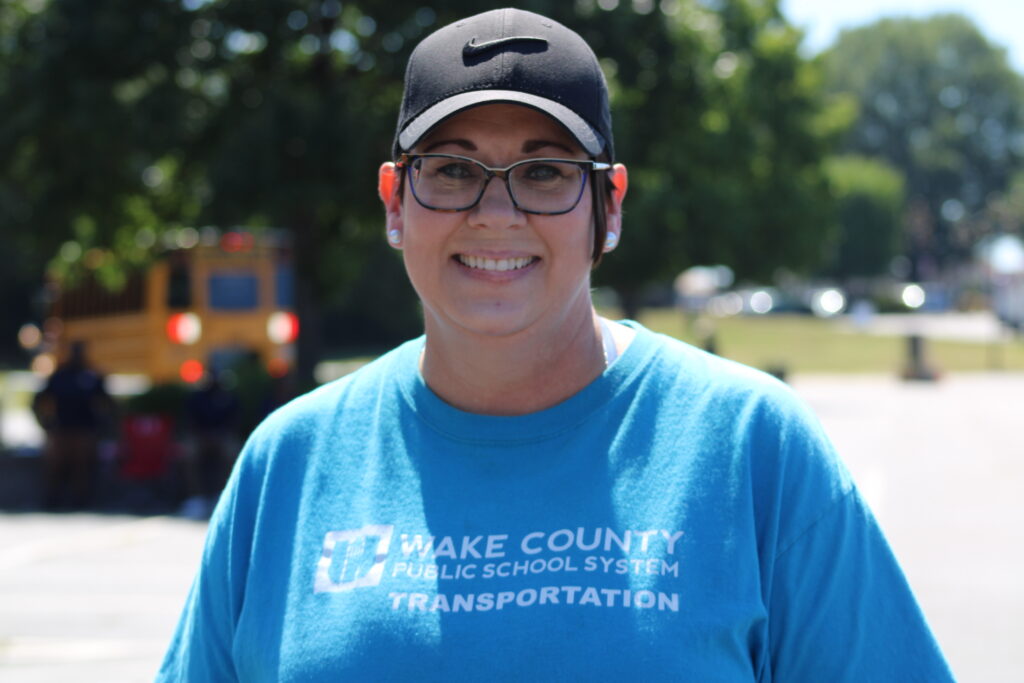 woman smiling in blue wake county public schools system shirt