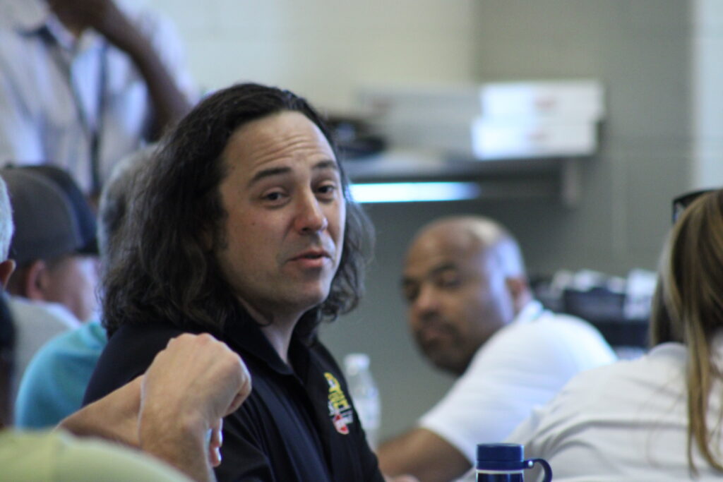 man sitting down with long hair