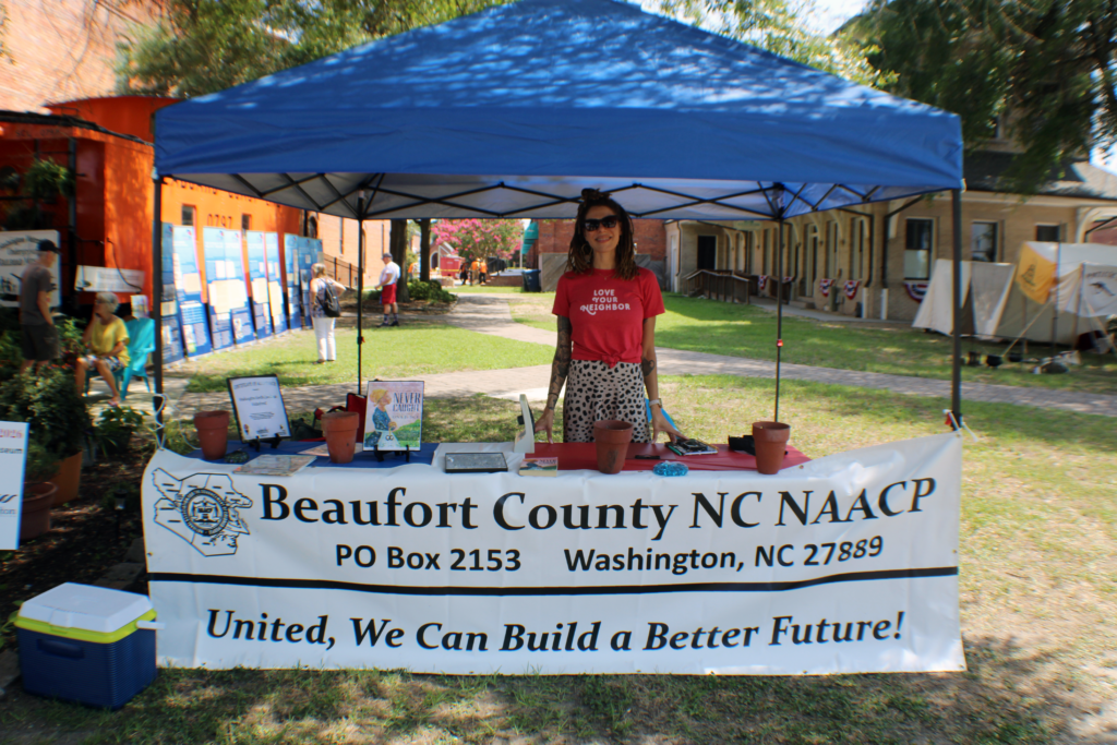 woman standing behind naacp table