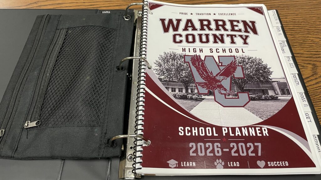 open black binder displaying warren county high school planner title page