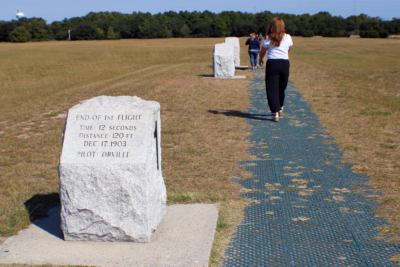 woman walking a path with commemorative stones