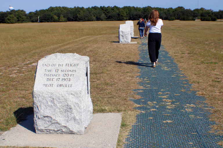 woman walking a path with commemorative stones